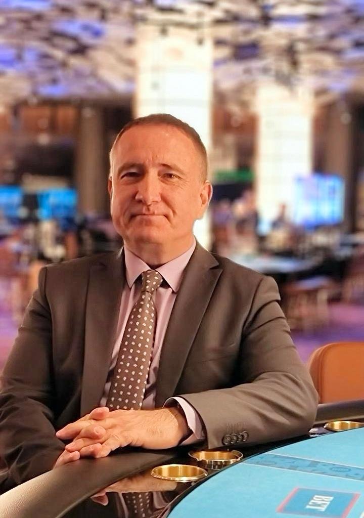 A professional casino manager overseeing gaming operations on the casino floor, strategically ensuring compliance, customer satisfaction, and operational efficiency